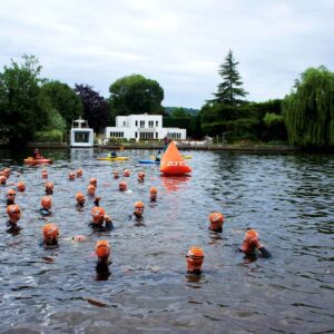 Participants wading through the river during the event.