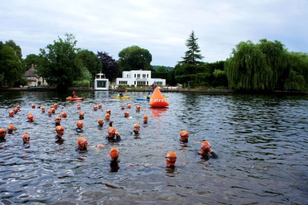 Participants wading through the river during the event.